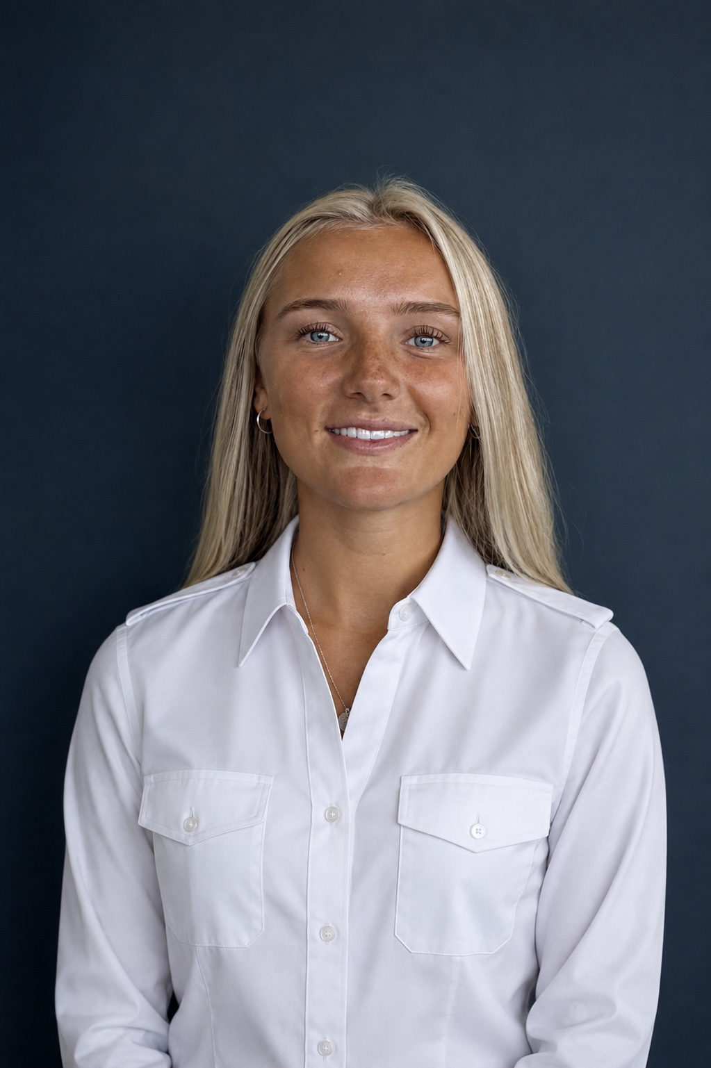 Maddi McCabe in a white pilot flight shirt